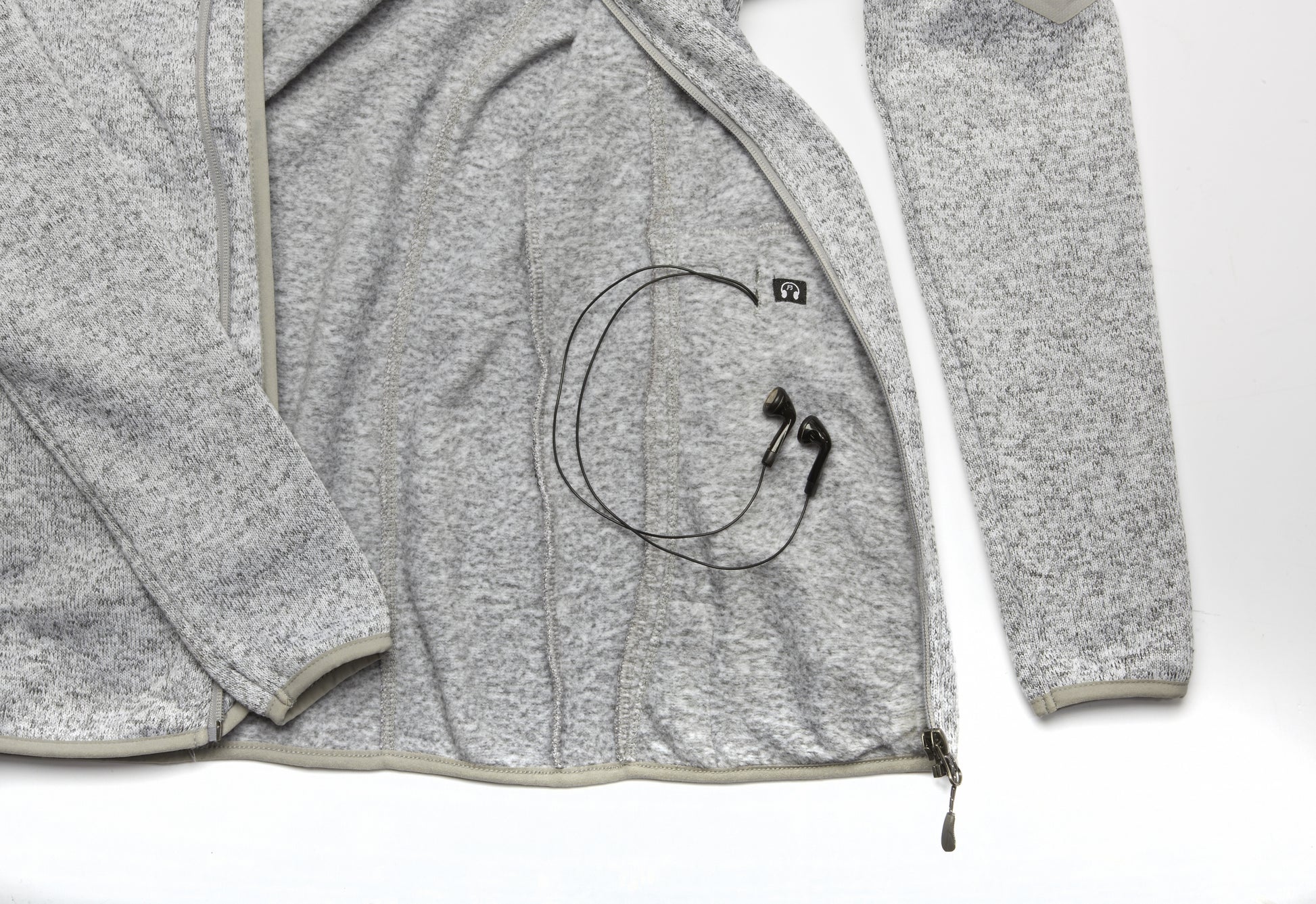  Interior pocket of the Women's Fairbanks Fleece in Heather Stone, showing the hands-free phone pocket with a pass-through headphone port.